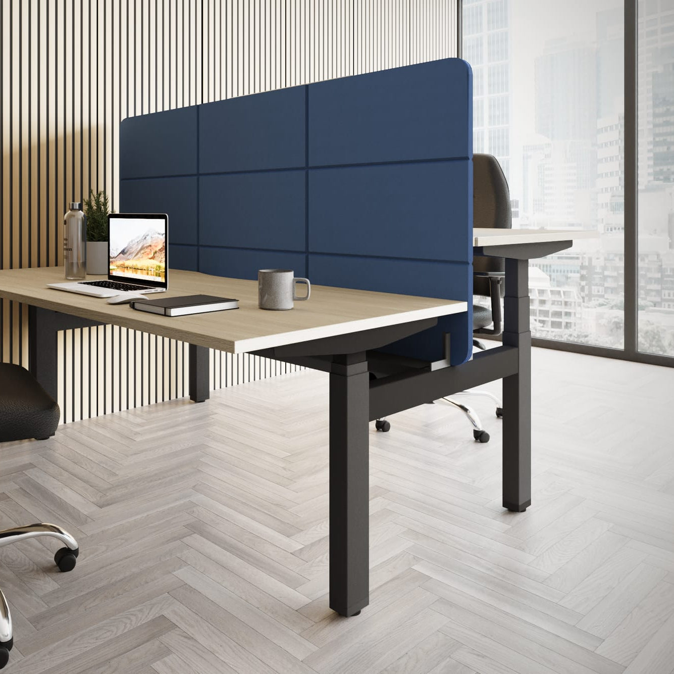 Modern office desk setup with a chair, computer, and blue partition.