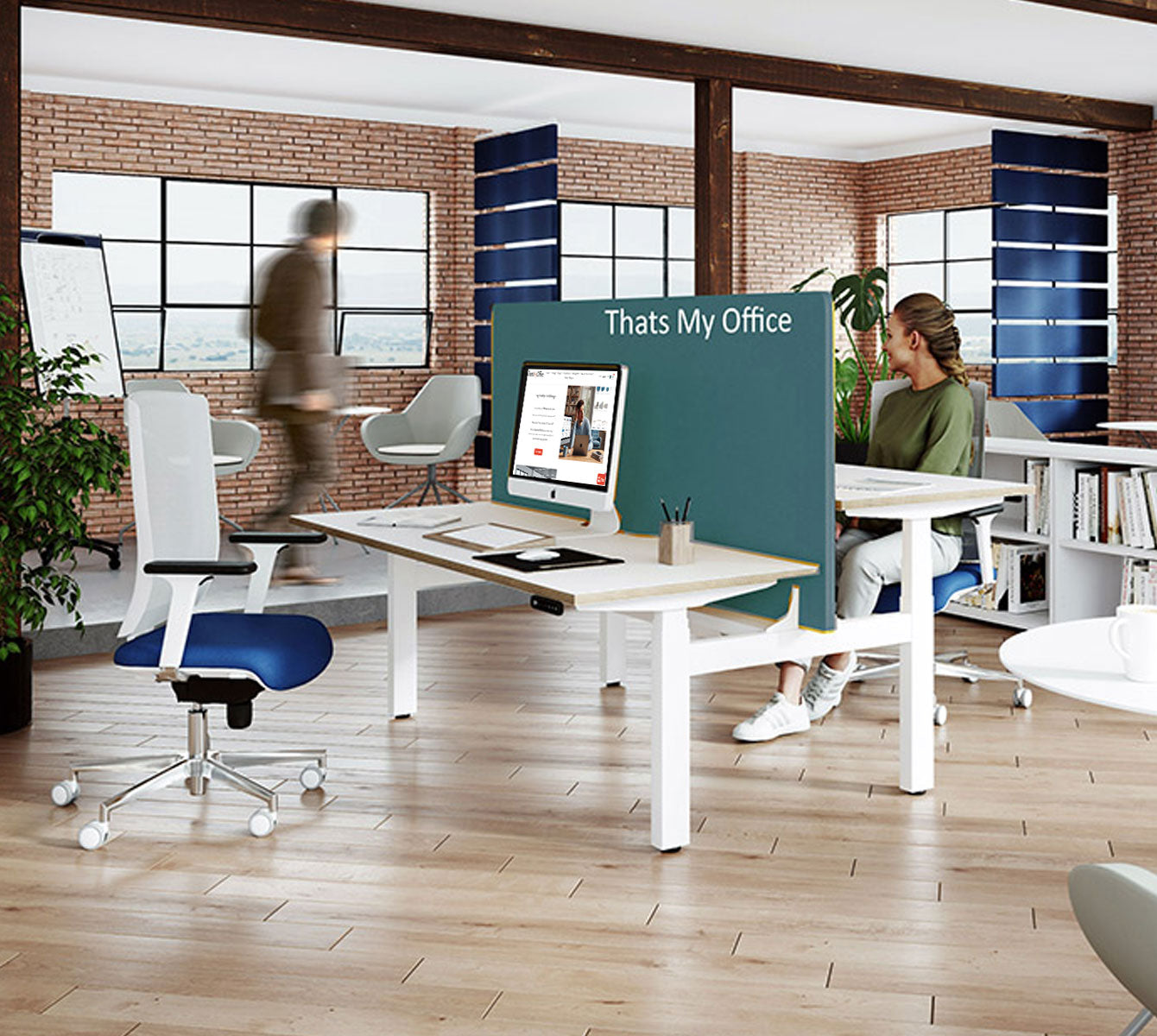 Modern office space with desks, chairs, and a large screen displaying 'That's My Office'.