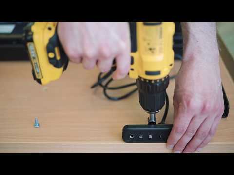 Person using power drill to assemble a desk