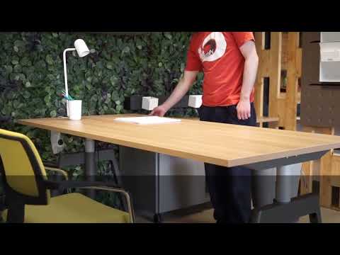 Modern office with large wooden desk and task lighting