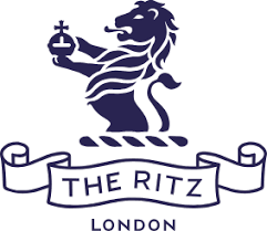 Logo of The Ritz London featuring a lion holding a key above a banner.