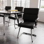 Modern conference room with black chairs and table near large windows.