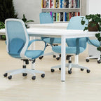 Modern office setup with blue chairs and white tables in a well-lit room.