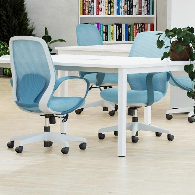 Modern office setup with blue chairs and white tables in a well-lit room.