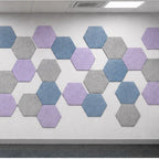 Hexagonal wall pattern with three colors on a white wall.
