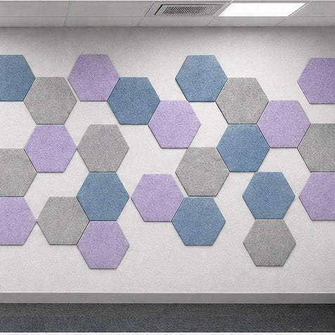 Hexagonal wall pattern with three colors on a white wall.