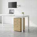Wooden file cabinet with three drawers on a white background