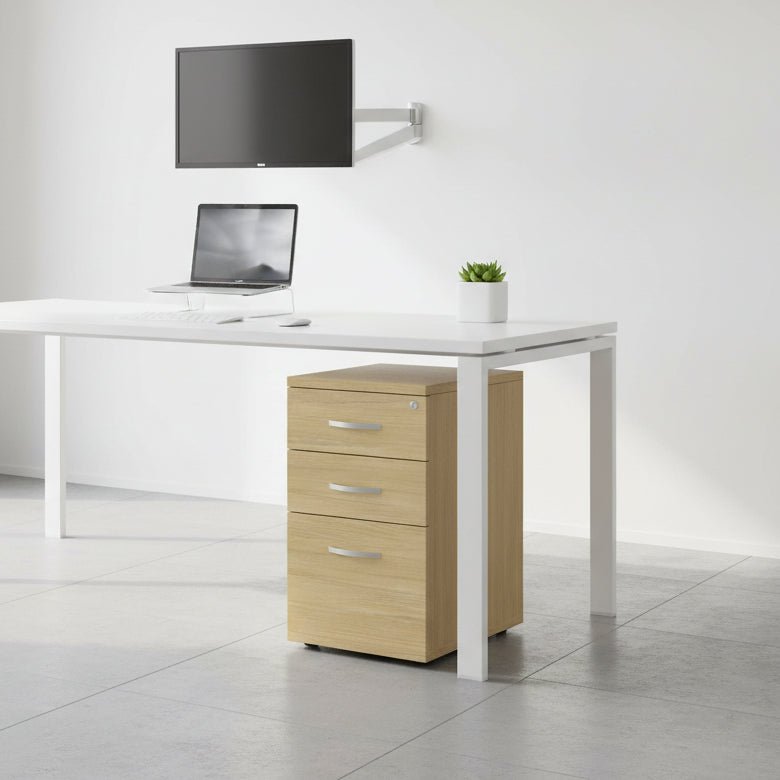 Wooden file cabinet with three drawers on a white background