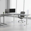 L-shaped desk with gray top and white legs on a white background