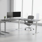 L-shaped desk with gray top and white legs on a white background