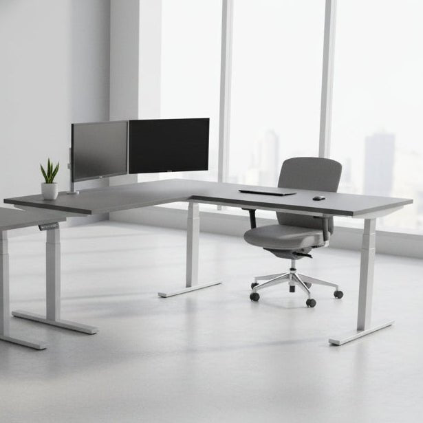 L-shaped desk with gray top and white legs on a white background