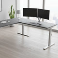L-shaped desk with gray top and white legs on a white background