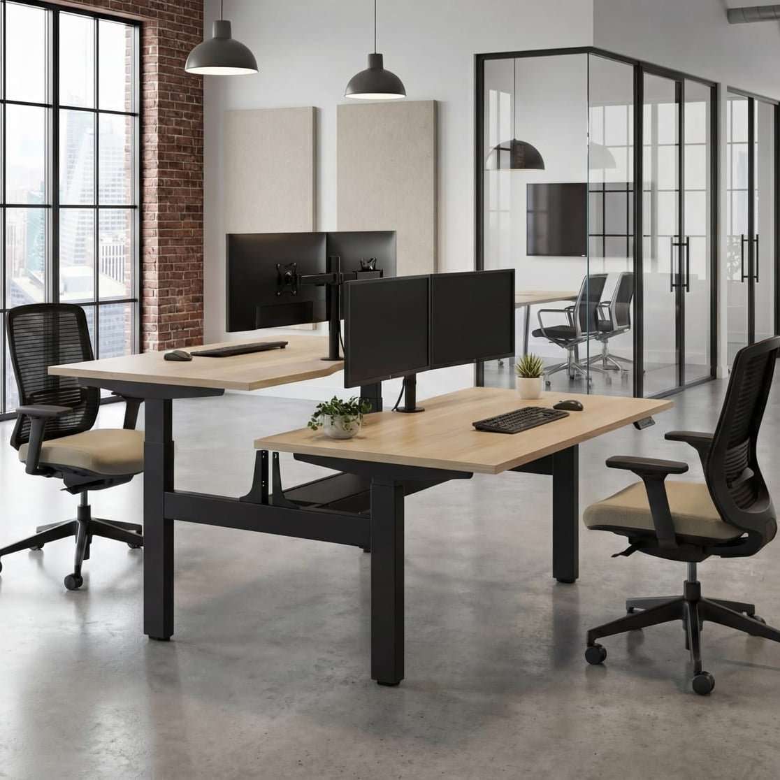 Contemporary office interior with dual monitor desks and glass partitions