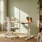 Modern home office with a desk, chair, and bookshelf.