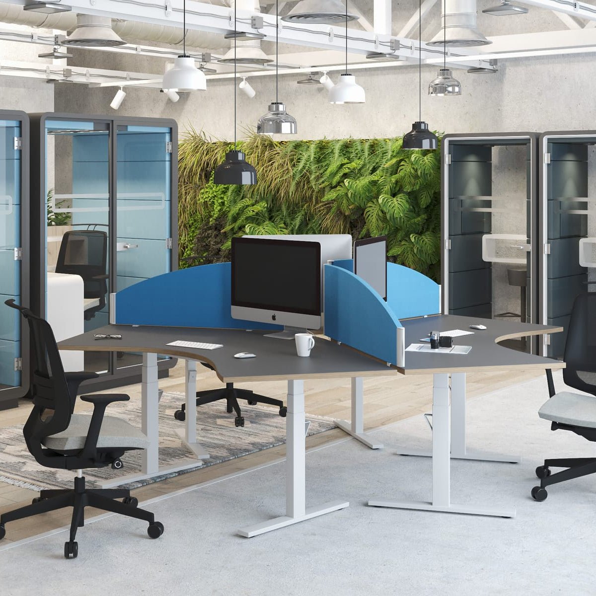 Modern office setup with glass partitioned workstations and a standing desk.
