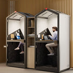Two office pod booths with people working inside on laptops.