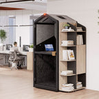 Modern office setup with a privacy pod and a person working at a desk.