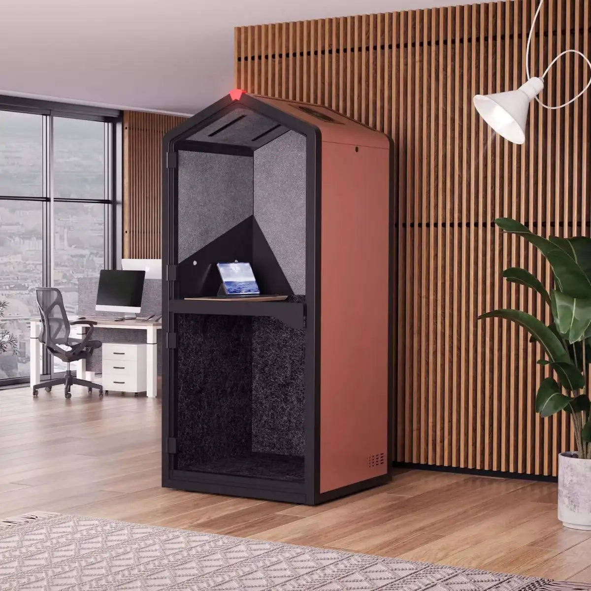 Modern office space with a large black and red speaker or monitor in the foreground.