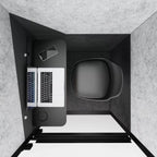 Small office desk with laptop, phone, and mug in a compact space.