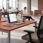 Modern office space with desks, chairs, and people working.