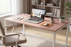 Pink office desk with laptop, chair, and decor in a bright room