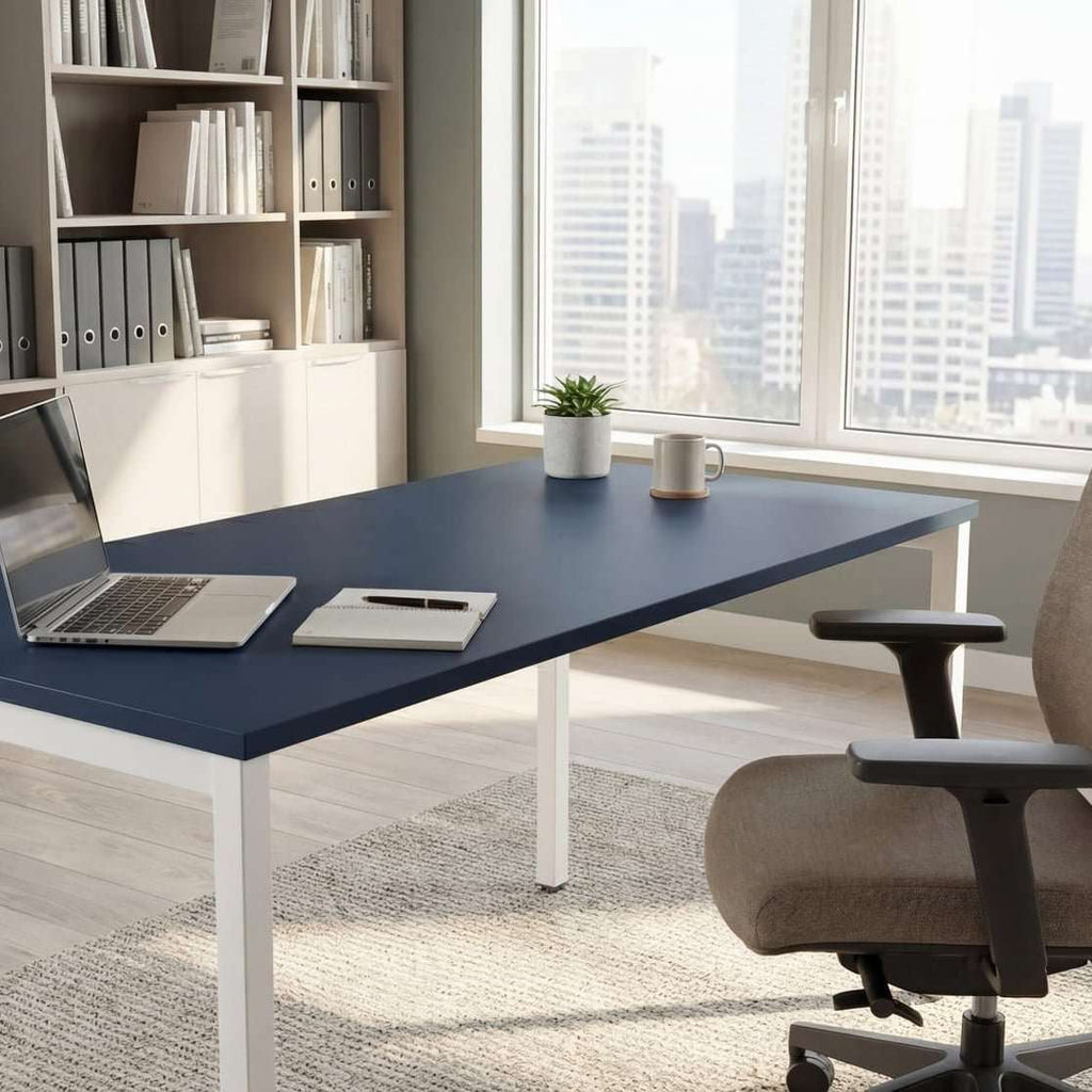 Modern office desk with a laptop, chair, and bookshelves in a bright room.