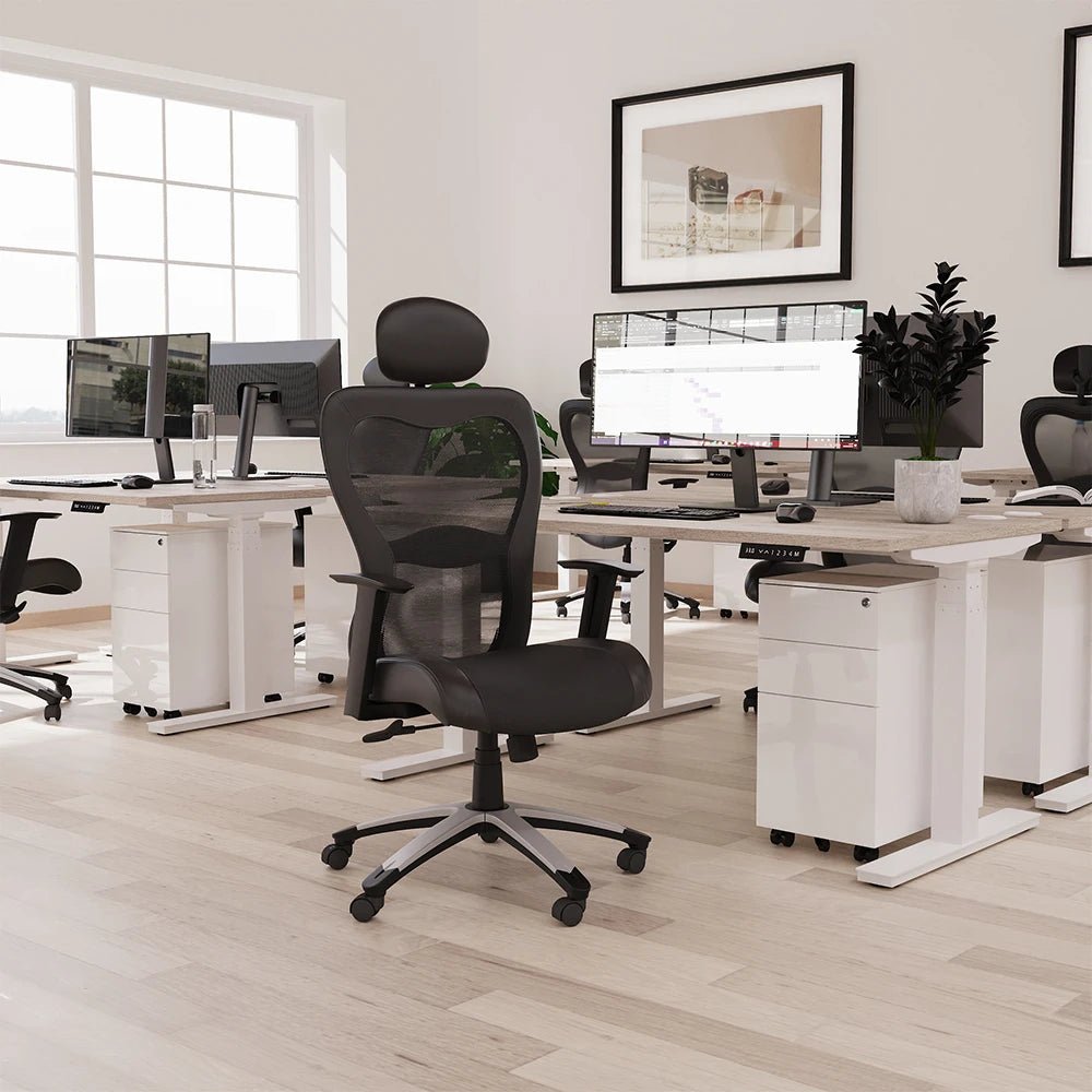 Modern office setup with desks, chairs, and computer monitors.