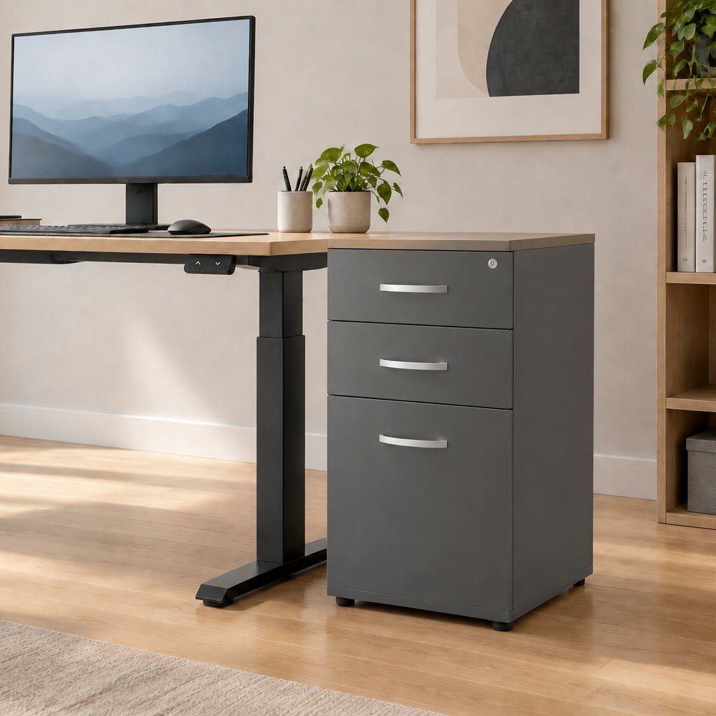 A three-drawer gray filing cabinet with silver metal handles, shown from a three-quarter angle on a clean white background.