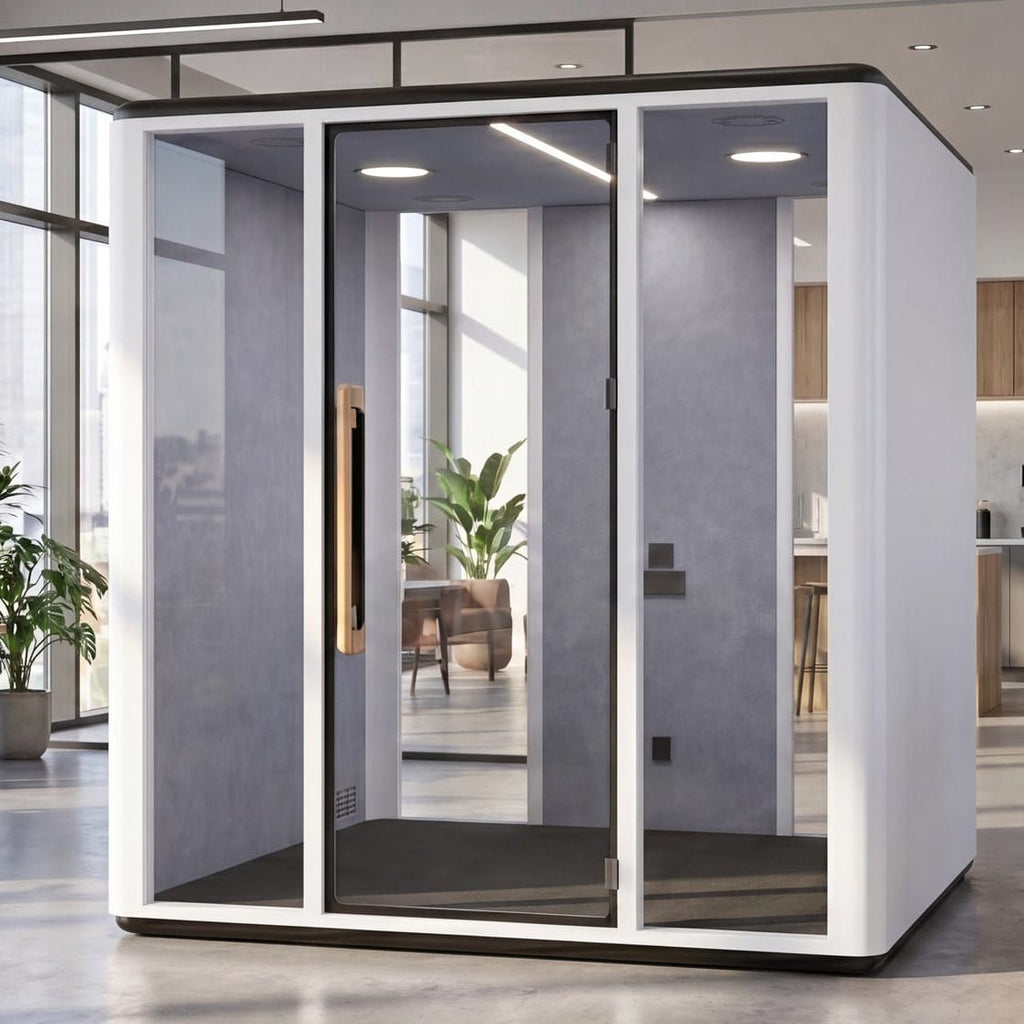 A modern white and gray glass privacy pod phone booth with a gold handle, shown in a bright, contemporary office environment.