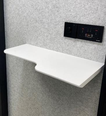 White shelf mounted on a gray wall with control panel above